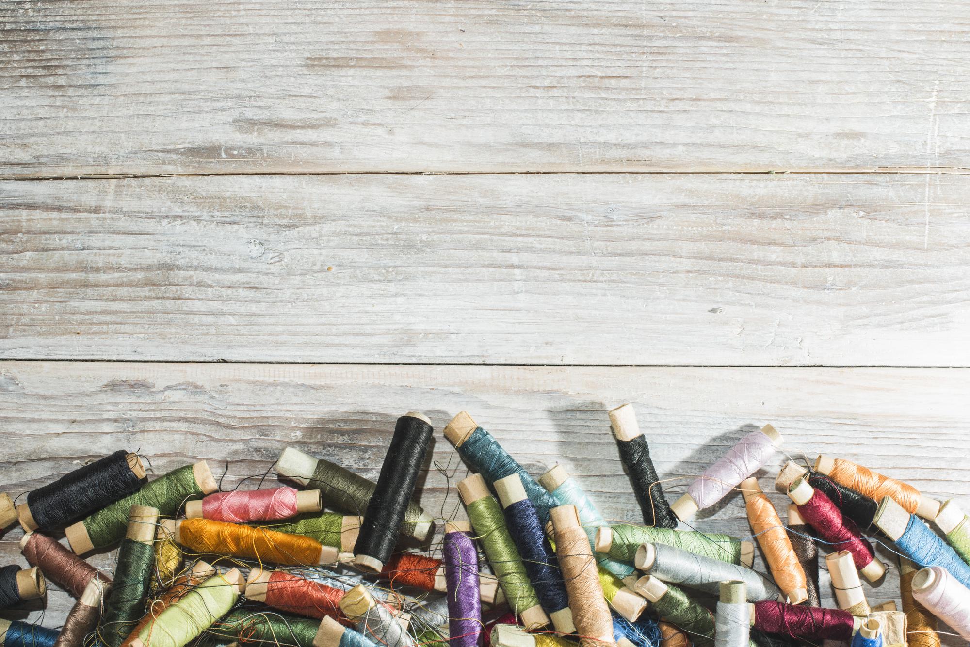 flatlay of embroidered samples and thread spools